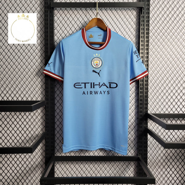 Camisa Oficial do Manchester City 22/23 - Tríplice Coroa